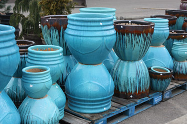 Turquoise blue pots of various sizes, part of Bark & Garden's extensive pottery selection.