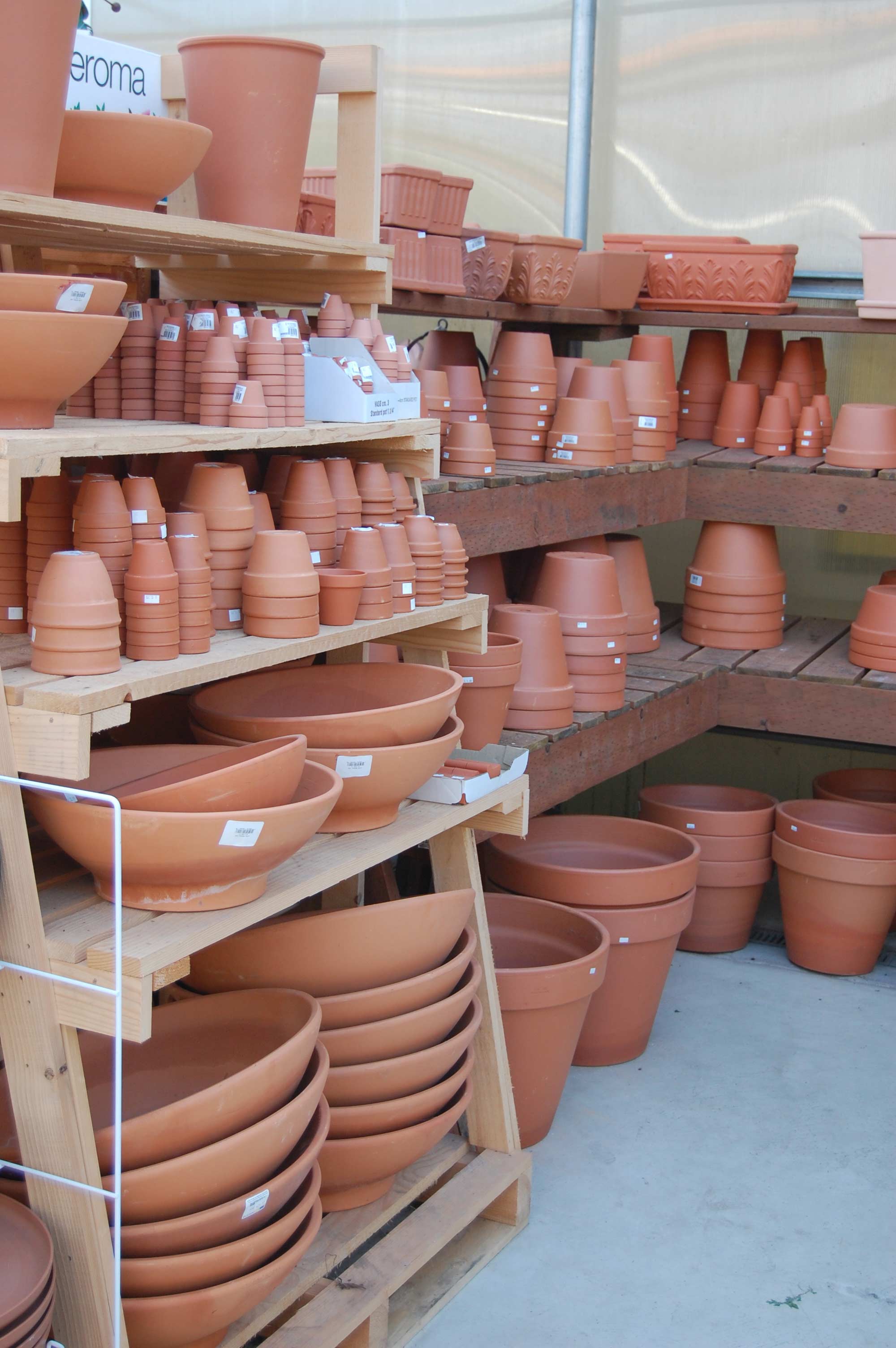 A 5-tiered shelf filled with pottery of various shapes and sizes.